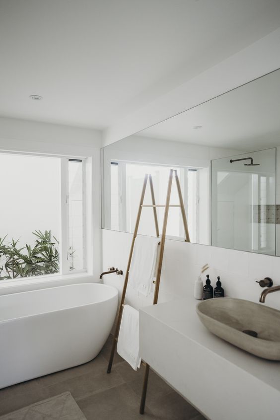 Wooden Ladder Holds Towels Near the Tub