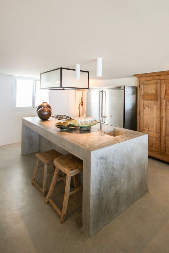 Monolithic Concrete Island With Integrated Sink and Rustic Stools