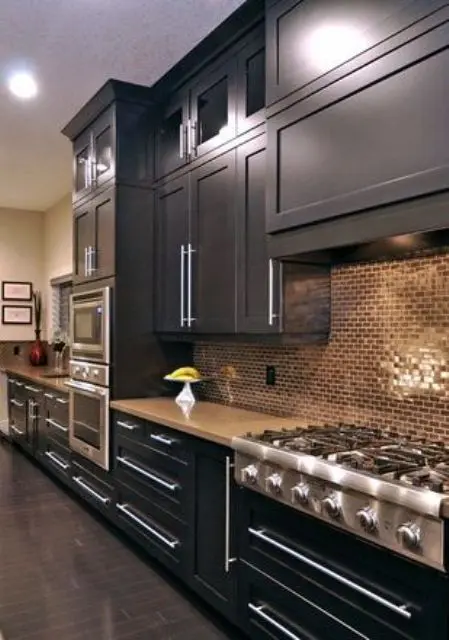 Earthy Mosaic Tiles Add Warm Texture Behind Dark Cabinets