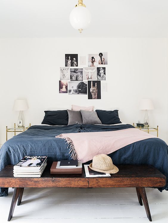 Gallery Wall of Black and White Photos Above the Bed