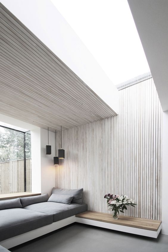 Light Wood Ledges Add Warmth To Vertical Paneling