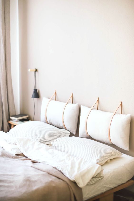 Leather Straps Hold Pillows as a Minimalist Headboard