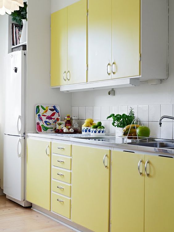 Pale Yellow Cabinetry with Simple Silver Pulls