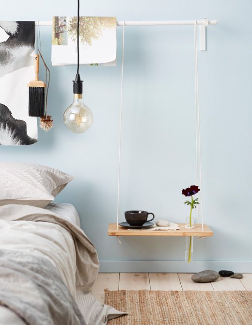 Light Wood Shelf Hung by Thin Cords with Bud Vase