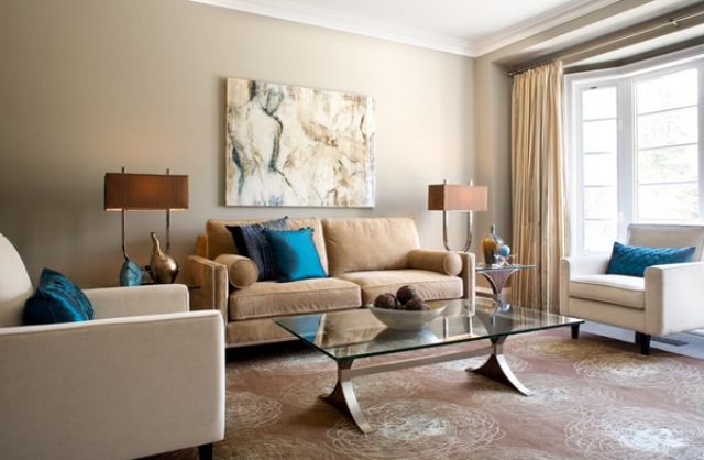 Ground Your Seating Area with a Glass Coffee Table and Abstract Art