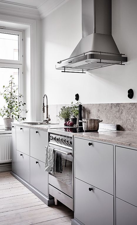 Achieve a Streamlined Look with Matte Grey Cabinets and Black Knobs