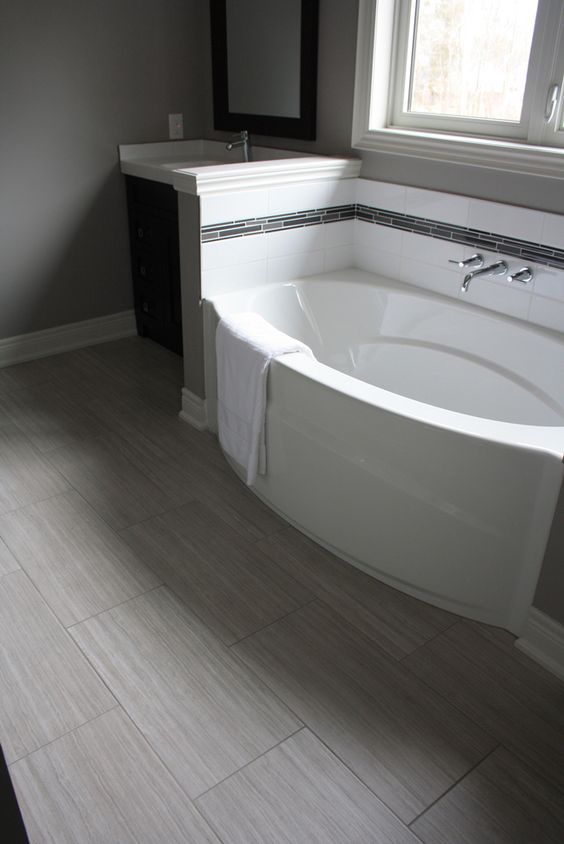 Long, Light-Wood Look Tiles Create a Wide, Open Bathroom Floor