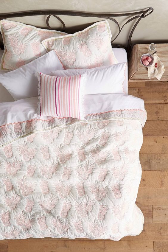 White Quilt With Pink Pineapple Appliqués Adds Playful Texture