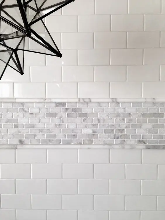 Marble Mosaic Border Adds Textured Detail Between White Subway Tiles