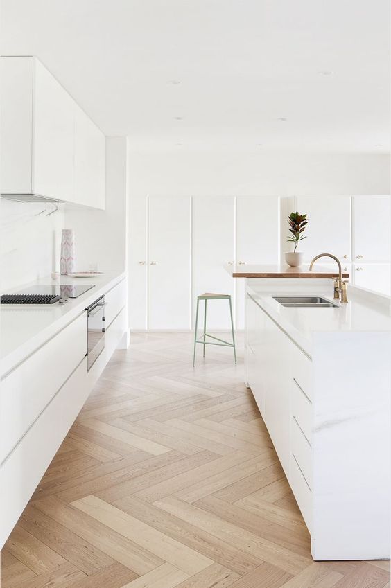 Herringbone Wood Floors Add Natural Texture to White Kitchen