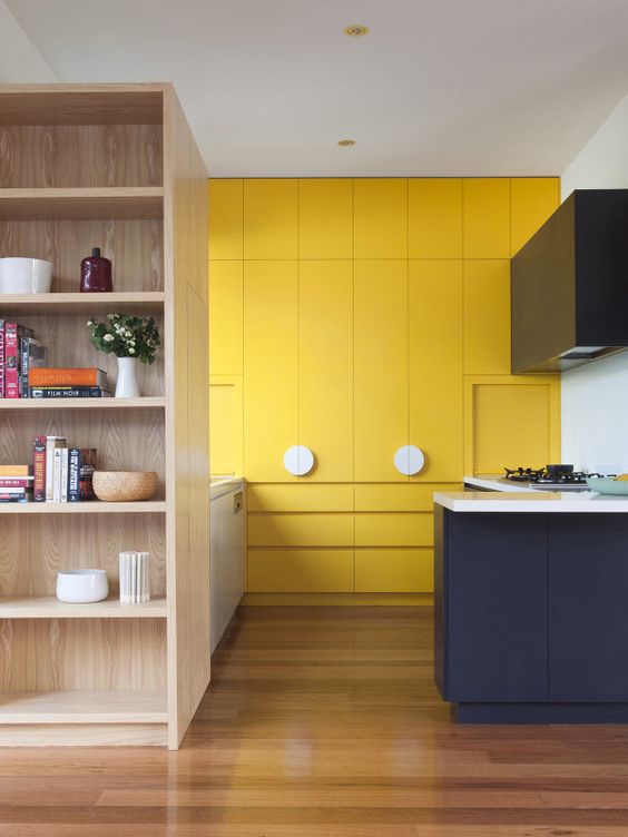 Wooden Shelving Adds Natural Texture Next to Yellow Cabinets