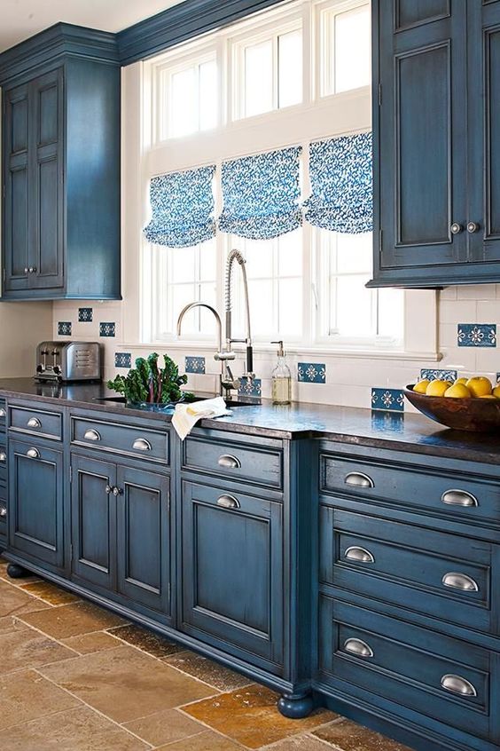 Distressed Blue Cabinets with Arch Pulls Add Rustic Charm
