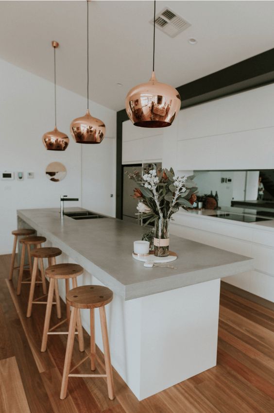 Polished Copper Pendants Add Warm Glow Above Island