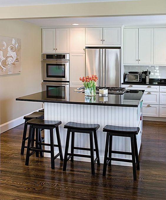 Black Stools Add Contrast To White Beadboard Island