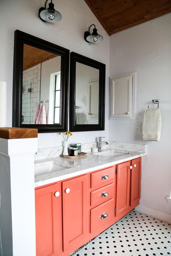 Coral Vanity With Black Mirrors Adds a Playful Contrast