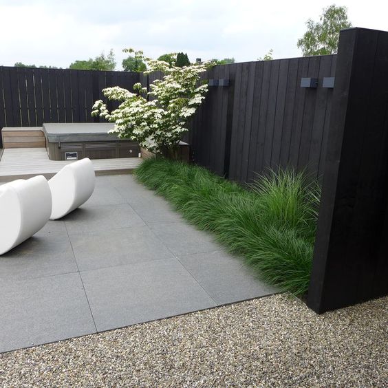 Low Grass Borders Soften Modern Paving and Fences