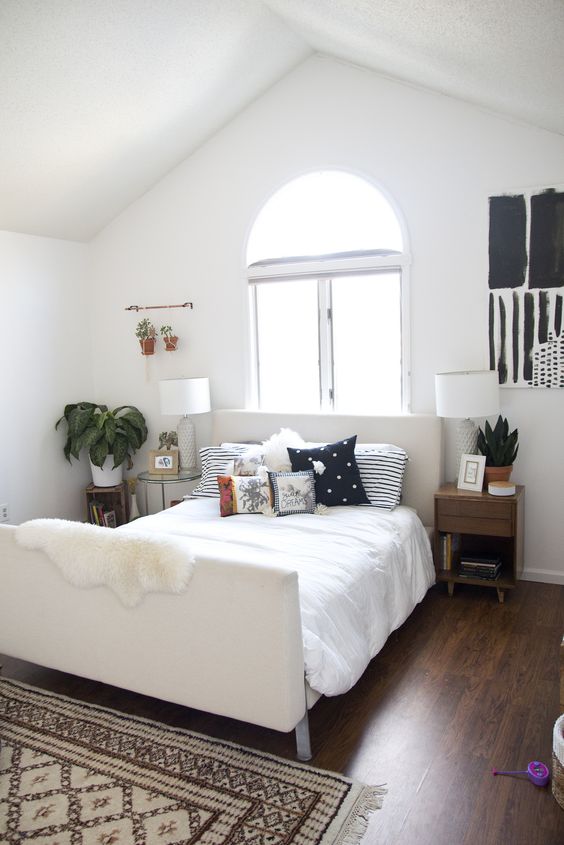 Copper Rods Hold Hanging Potted Plants Above Bedside Tables