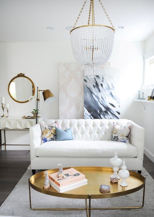 Oval Brass Coffee Table with Stacked Books and Giraffe Figurines