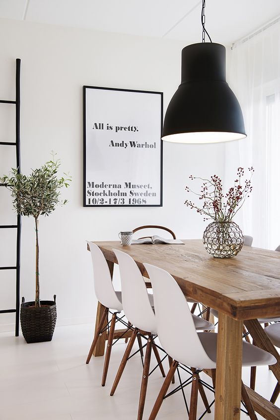 Large Black Pendant Light Anchors the Dining Table