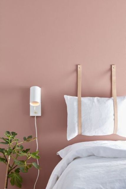 Leather Straps Suspend a Pillow for a Soft Headboard