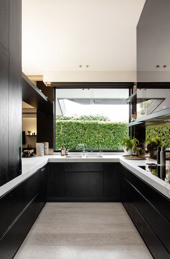 Matte Black Cabinetry With Marble Countertops Creates Contrast