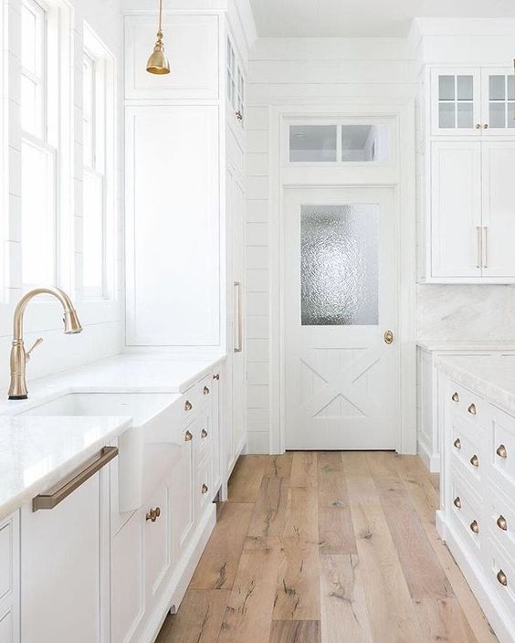 Accent Tall White Cabinets with a Brass Pendant Light