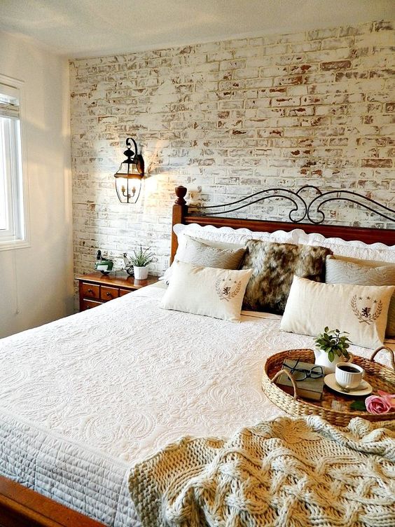 Whitewashed Brick Wall Adds Rustic Texture Behind the Bed