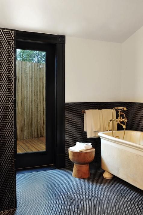 Wooden Pedestal Stool Adds Natural Touch Next to Bathtub