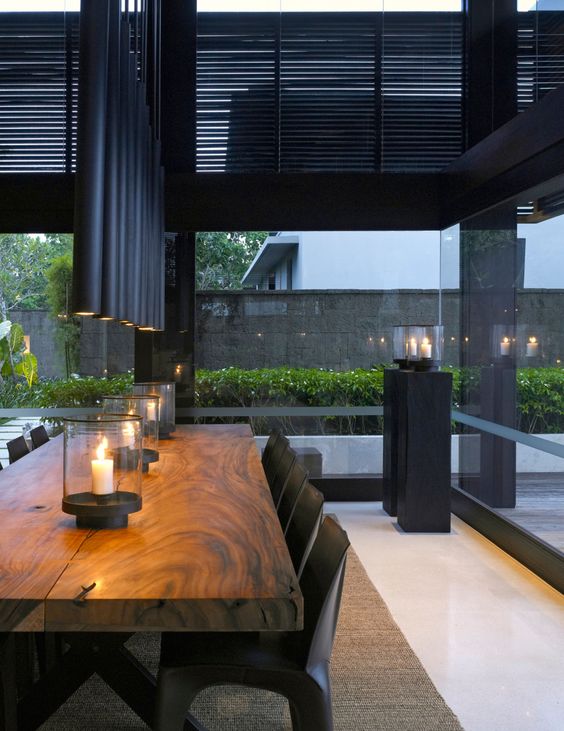 Glass Hurricane Lanterns Add Warm Ambiance to Wooden Table