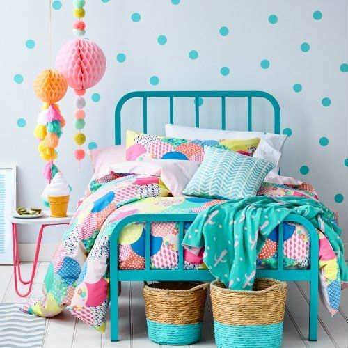Turquoise Bed Frame Anchors a Pattern-Filled Room