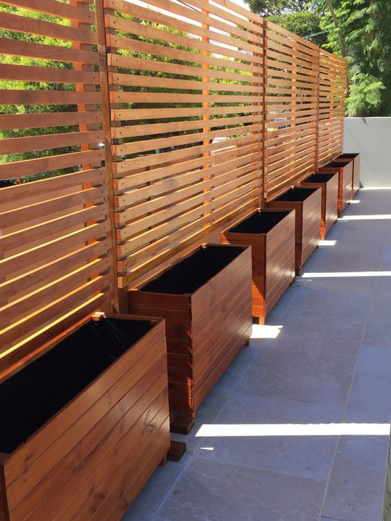Line Your Fence with Wooden Planters for a Green Border