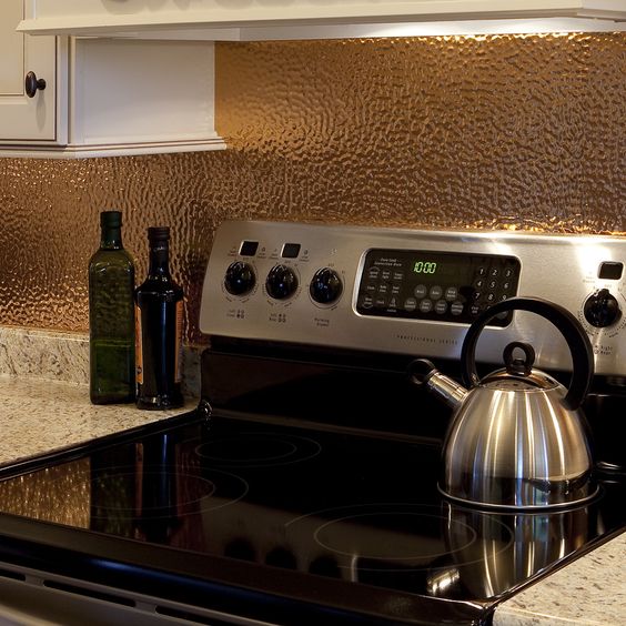 Textured Copper Backsplash Adds Warmth Behind Stove
