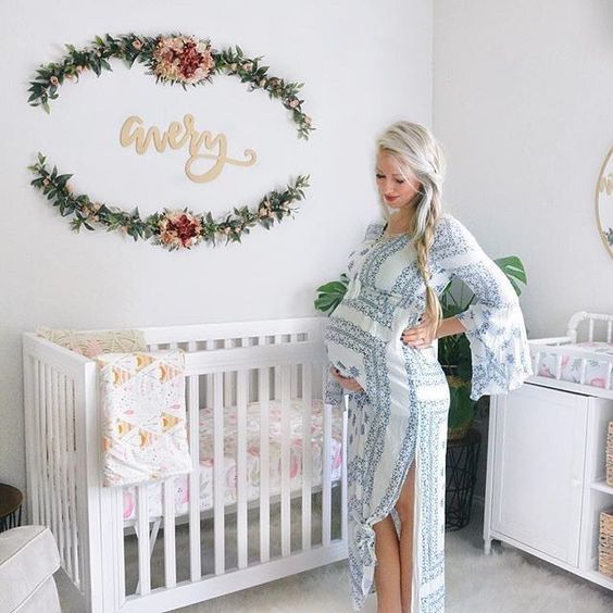 Oval Floral Garland Frames a Wooden Name Sign