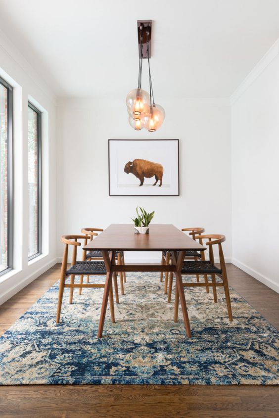 Large Framed Artwork Anchors a Dining Space