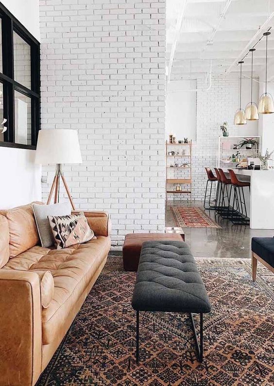 Soften a Leather Sofa with a Tufted Ottoman