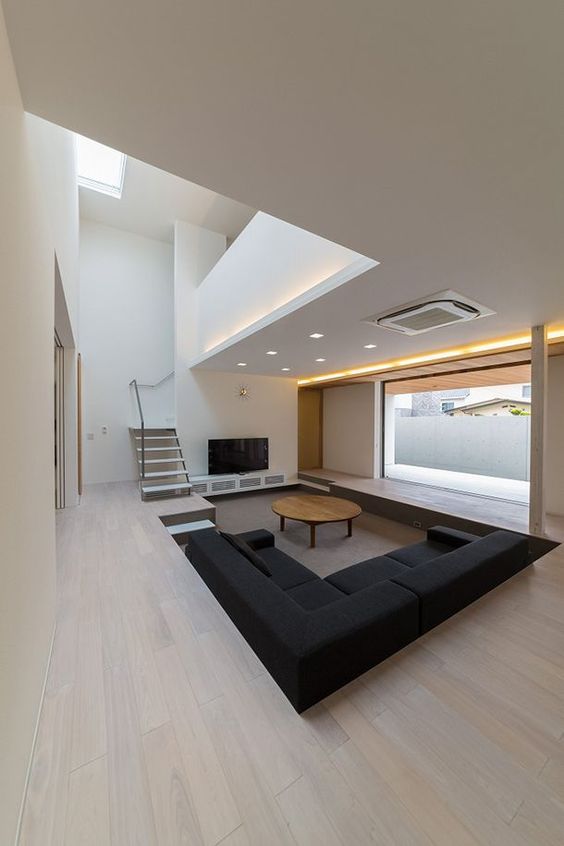 Dark Sectional Sofa Anchors the Sunken Conversation Zone