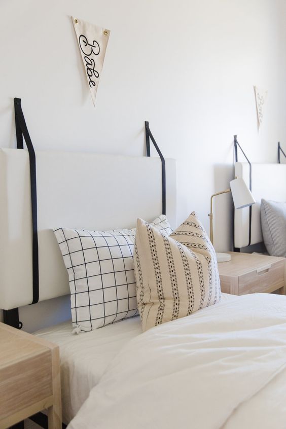 White Padded Headboard Hung with Black Straps