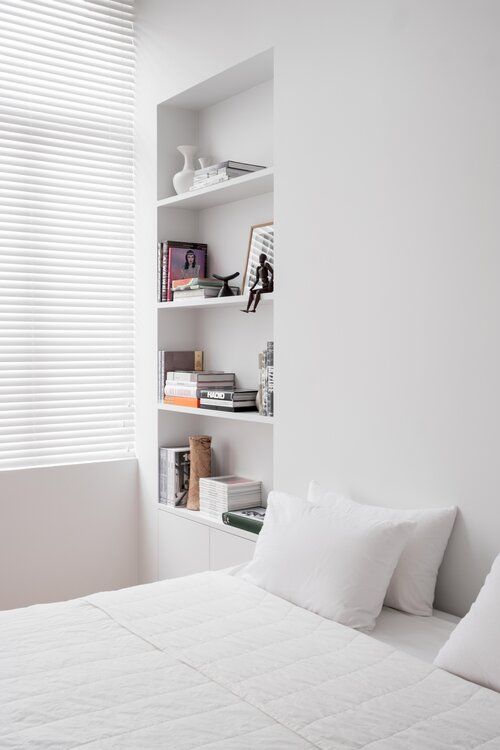 Showcase Art Books and Vases in Tall, White Niches