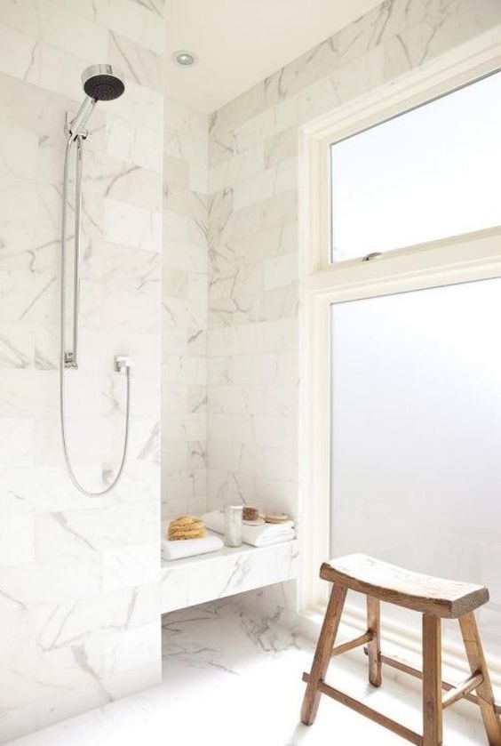 Rustic Wooden Stool Adds a Natural Element to Marble Shower