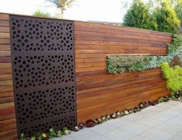 Dark Metal Screen With Organic Cutouts Adds Patterned Privacy