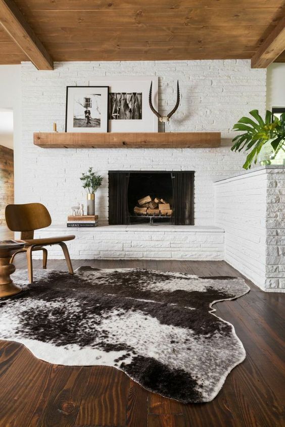 Animal Hide Rug Adds Bold Contrast To Dark Wood Floors