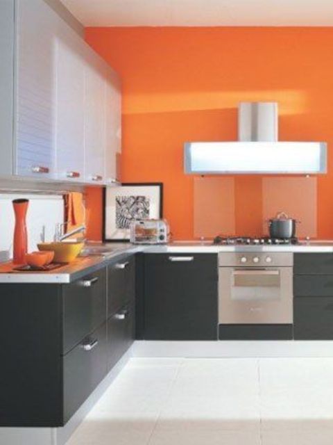 Orange Wall Creates a Bold Backdrop for Sleek Kitchen Appliances