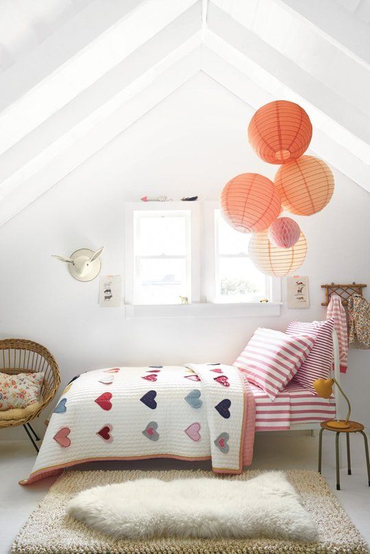 Coral Paper Lanterns Add a Playful Touch to the Sloped Ceiling