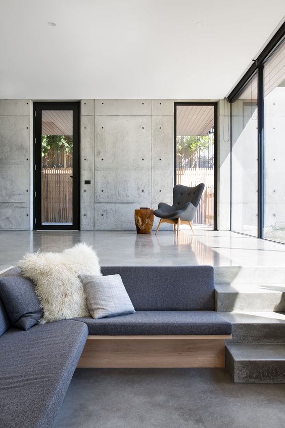 Built-in Wood Bench Seat Adds Warmth to Concrete Living Area