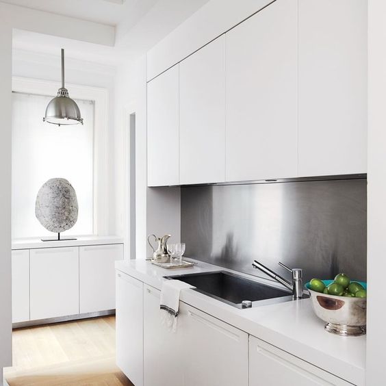 Reflect Light in a Minimalist Kitchen with a Brushed Metal Backsplash