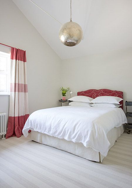 Patterned Headboard Adds a Pop of Red to Neutral Walls