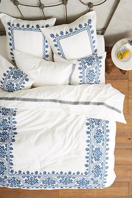 White Bedding with Intricate Blue Border Patterns