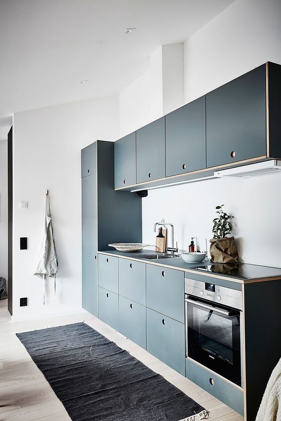 Pale Blue Cabinets with Circular Cut-Out Handles