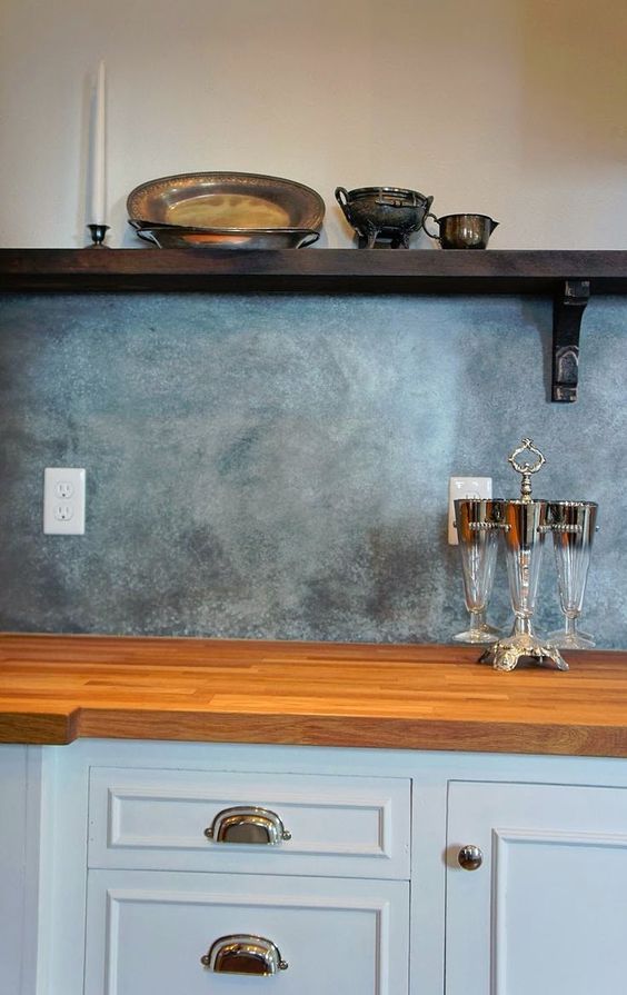 Textured Grey Backsplash With Ornate Silverware Display