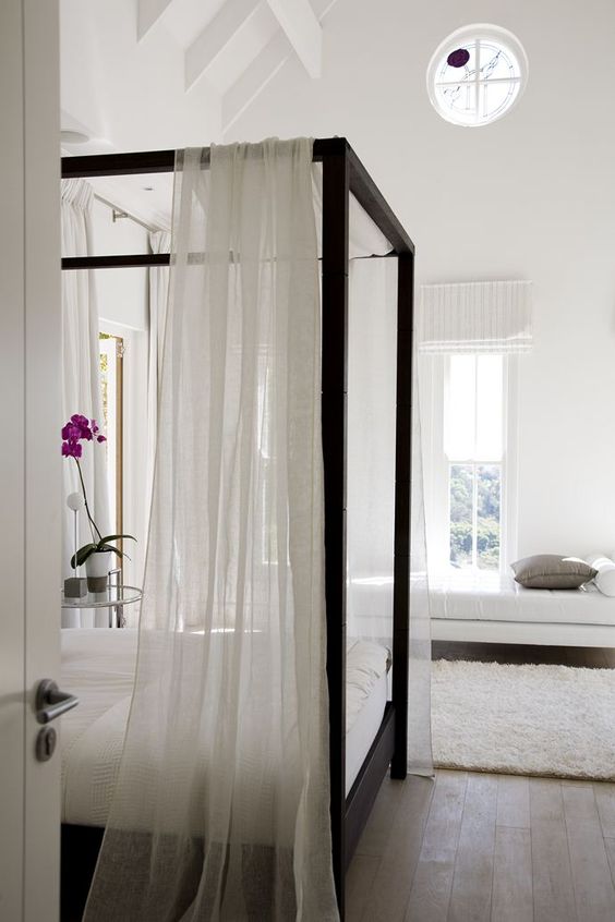 Drape Sheer White Fabric on a Dark Wood Canopy Bed